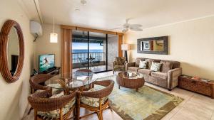 a living room with a table and chairs and a couch at Kona Reef A32 in Kailua-Kona