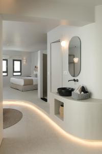 a bathroom with a sink and a mirror at Anapollo Boutique Hotel Adults Only in Naxos Chora