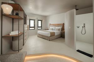 a bedroom with a large bed and a bathroom at Anapollo Boutique Hotel Adults Only in Naxos Chora +91 photos