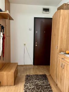 eine Küche mit einer schwarzen Tür und einem Holzschrank in der Unterkunft Cosy apartment Sarajevo in Sarajevo