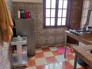 a toy kitchen with a refrigerator and a sink at Appartement Relax Marrakech, شقة عائلية بمراكش متوفرة على غرفتين in Marrakesh