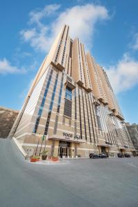 a tall building with a vogel at voco Makkah an IHG Hotel in Mecca