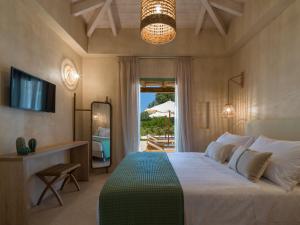 Postel nebo postele na pokoji v ubytování Terra Oleana Cottages + 37 fotografií