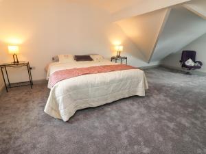 a bedroom with a large bed in a attic at Teach De Barra 