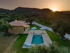 an aerial view of a villa with a swimming pool at Terra Oleana Cottages in Vasilikos