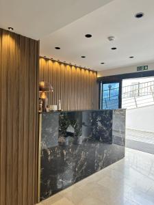 a lobby with a marble counter and wooden walls at Dolce Bella Suites in Trabzon
