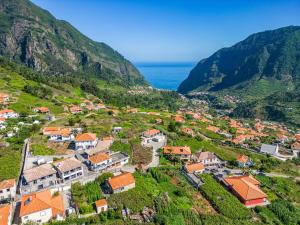 an aerial view of a village on a hill with the ocean at Basalt Dwelling I by Madeira Sun Travel in São Vicente