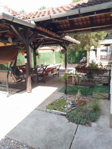 a patio with a wooden pergola and a table at Apartman Palić Libero in Palić