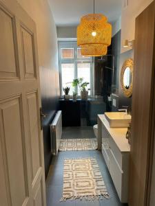 a bathroom with a sink and a toilet and a mirror at Apartament Tuchola in Tuchola