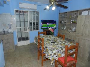 a dining room with a table and a tv at Lo de Lili in Puerto Madryn