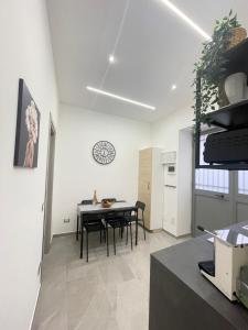 a kitchen and dining room with a table and chairs at IL VICOLO DI PAOLA in Catania