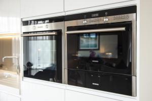 a kitchen with two ovens in a kitchen at Luxurious apartment 10 minute walk from Old Course in St Andrews