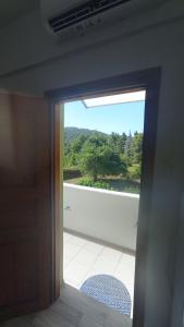 an open door with a view of a balcony at Villa Sandra in Panormos Skopelos