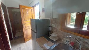 a kitchen with a refrigerator and a sink at Villa Sandra in Panormos Skopelos
