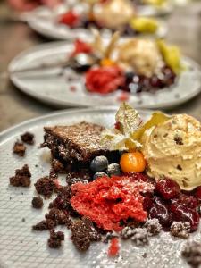 a plate of food with cake and ice cream at Landhaus Sollingshöhe in Holzminden