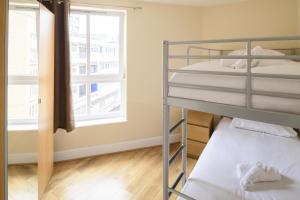 two bunk beds in a room with a window at The Tower Bridge Cosy Flat in London