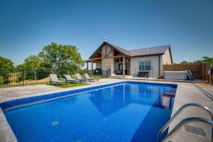 a swimming pool in front of a house at Idyllic Williamstown Retreat with Hot Tub and Pool! in Williamstown