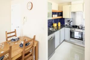 a kitchen with a table and a dining room at The Tower Bridge Cosy Flat in London