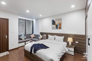 a bedroom with a large bed and a window at NB APARTMENT - KIM MA in Hanoi