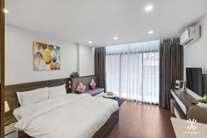 a bedroom with a large bed and a large window at NB APARTMENT - KIM MA in Hanoi