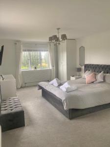 a bedroom with a large bed and a window at Boundary Farm in Middleton