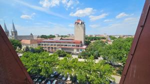 a view of a city with a clock tower at City Center Luxury Apartment in Subotica