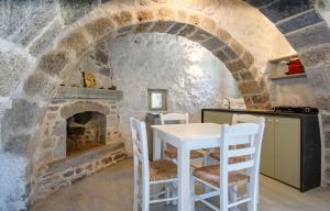 a kitchen with a table and a fireplace at Apostrophe Traditional Residence in Nisyros with arcurated interior. Privacy & Authenticity in Emporeiós