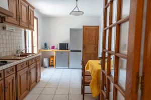 a kitchen with a sink and a refrigerator at Villa Naladijo 6 People heated swimming pool games 650m city center in Saint-Didier
