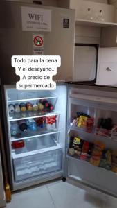 a refrigerator with its door open and a sign on it at Céntrico 04 in General Roca