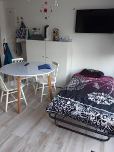 sypialnia z łóżkiem, stołem i krzesłami w obiekcie Le Repos'Han w mieście Han-sur-Lesse