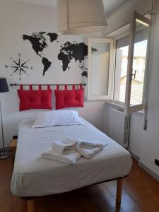 a bedroom with a large bed with towels on it at B&B Il Viaggiatore in Marina di Massa