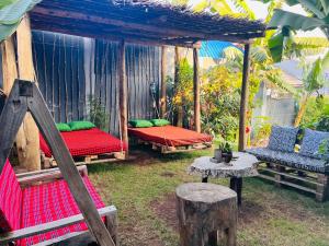 a gazebo with two beds and a table at Serengeti Villa in Arusha