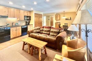 a living room with a couch and a table at On the Rapids in Grand Lake