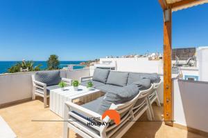 a balcony with a view of the ocean at #086 Fish House by Home Holidays in Albufeira
