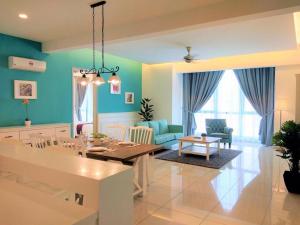 a dining room and living room with blue walls at Jazz Service Suite Tanjung Tokong in Bagan Jermal