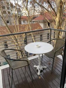 a white table and two chairs on a balcony at Nicaragua 6042 in Buenos Aires