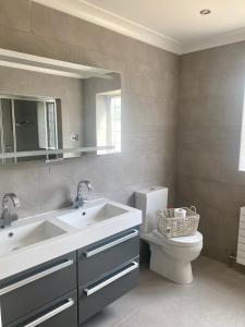 a bathroom with a sink and a toilet and a mirror at Boundary Farm in Middleton