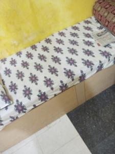 a mattress with purple flowers on top of it at Ilamathi hostel in Chennai