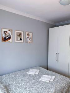 a bedroom with a bed with two towels on it at HALBY rooms Nowolipki 15 in Warsaw