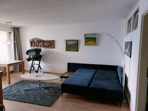 a living room with a bed and a table at Wohnung mit See und Bergsicht im vier Sterne Hotel in Beatenberg