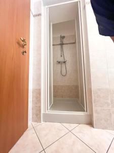 a shower with a glass door in a bathroom at Appartamenti gg - nel centro di Livigno- app.1 in Livigno