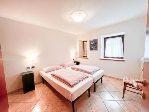 a bedroom with two beds and a window at Appartamenti gg - nel centro di Livigno- app.1 in Livigno