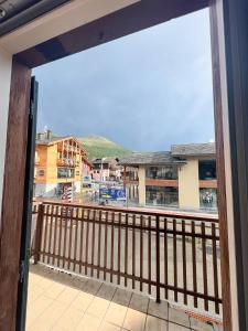 a balcony with a view of a city at Appartamenti gg - nel centro di Livigno- app.1 in Livigno