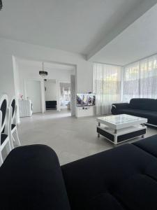 a living room with a couch and a coffee table at Residence Mary in Velipojë