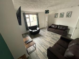 a living room with a couch and a chair at Viewlands house in Auchterarder