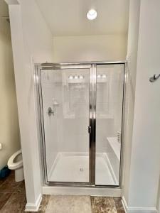 a glass shower in a bathroom with a toilet at Waterfront escape 