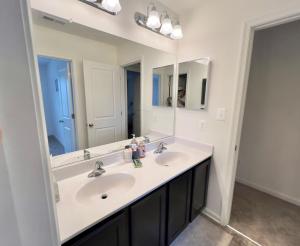 a bathroom with two sinks and a large mirror at Waterfront escape 