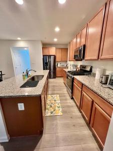 a large kitchen with wooden cabinets and a kitchen rug on the floor at Waterfront escape 