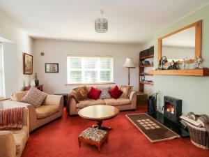 a living room with two couches and a fireplace at Hook Head Hideaway 