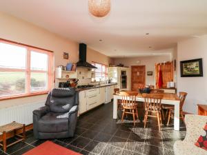 a kitchen and dining room with a table and chairs at Hook Head Hideaway 